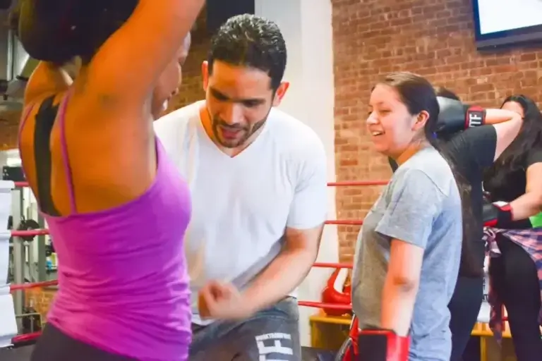 Work Train Fight instructor training member on punch.